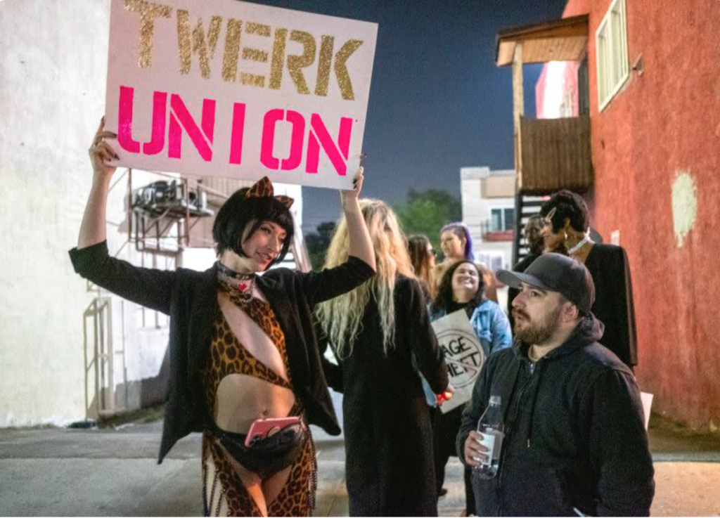 Reagan, left, a dancer at Star Garden, protests outside the North Hollywood strip club in March 2022. After a 15-month battle, the club's strippers will become the only ones in the U.S. to gain union recognition. (Francine Orr / Los Angeles Times)